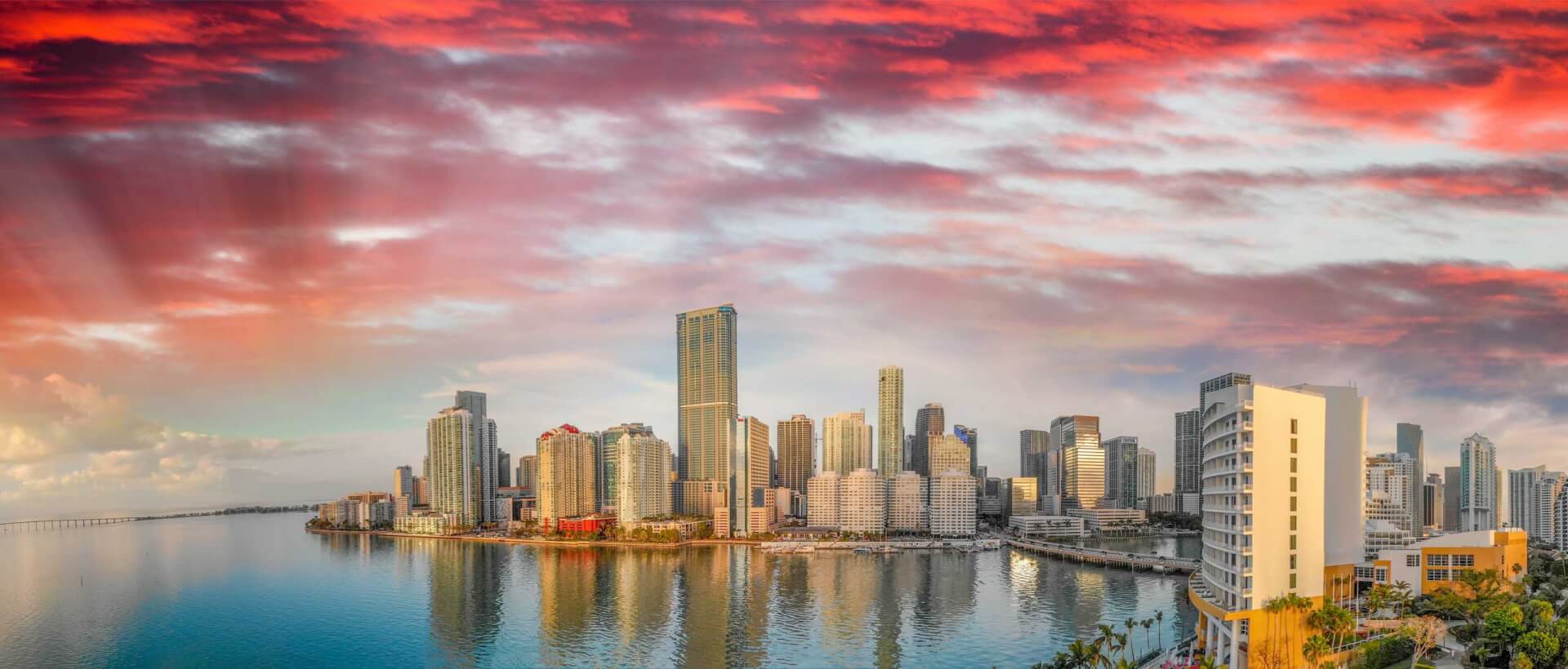 Panoramic aerial view of Downtown Miami and Brickell Key at sunrise.